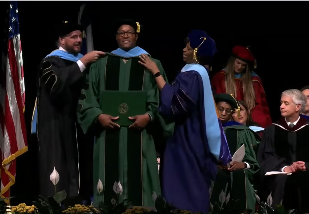Quincy K. Ruffin being hooded at his doctoral commencement ceremony
